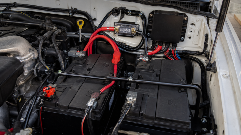 Dual battery setup in truck engine bay with DC-DC charger and ANL fuse block